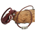 brown-leather-hammered-silver-buckle-wrap-bracelet-brown-leather-silver-cylinder-necklace-against-wood-white-background