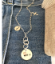 Sterling-multi-chain-mom-charm-necklace-on-denim-background