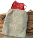 tan linen jewelry bag on wood