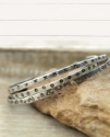 3 Sterling cuffs on a rock