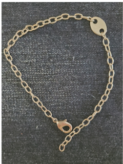hypoallergenic chain tag anklet on denim
