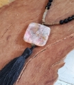 black gemstone tassel necklace on mannequin
