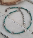 Turquoise wood beads & silver flower choker necklace on white wood