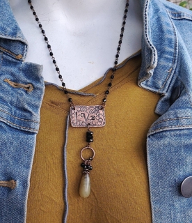 copper love tag necklace on mannequin