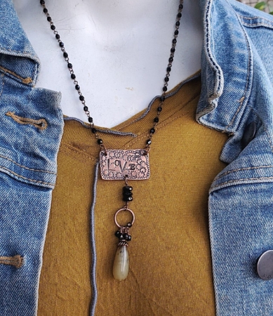 copper love tag necklace on mannequin