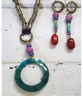 collorful beaded necklace earring on white trunk