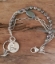 Pearl silver chain hummingbird bracelet on wood