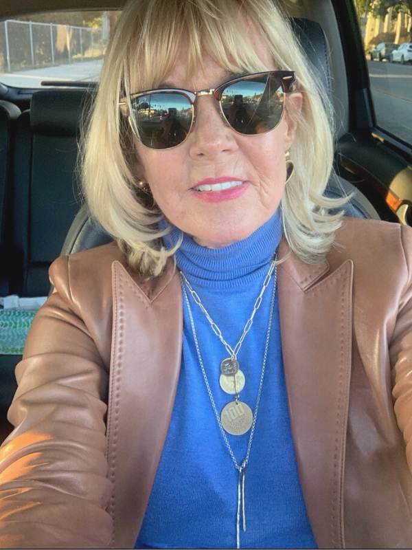 layered gold jewelry with a turtleneck