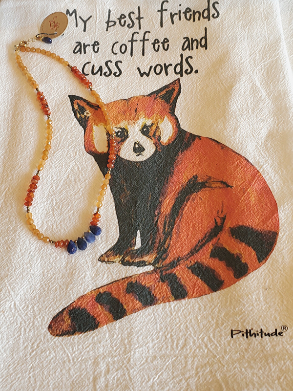 funny graphic hand towel with orange gemstone necklace