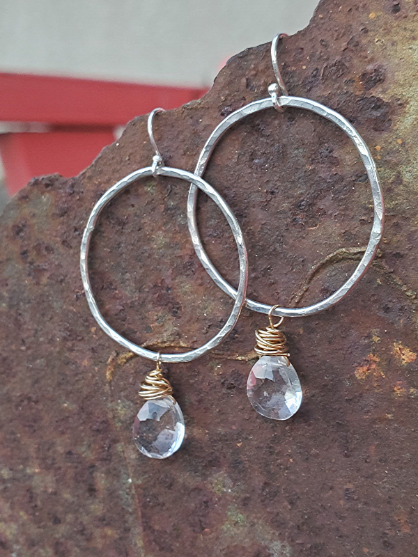 silver crystal hoops on rustic metal
