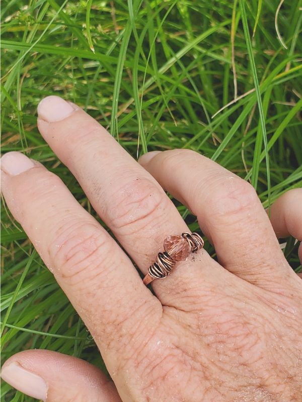 hand in pants with crystal copper ring