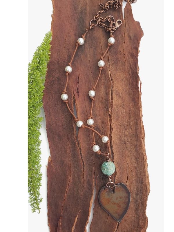 pearl leather heart necklace on wood