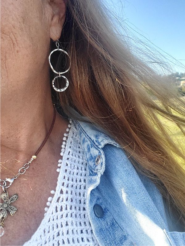 wearing earrings with long hair in the wind