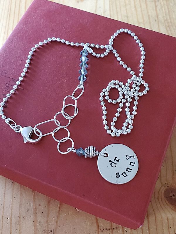 Sterling graduation necklace on red gift box