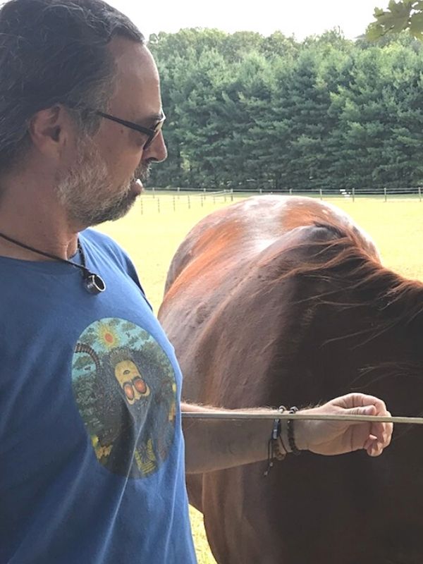 man with horse wearing jewelry