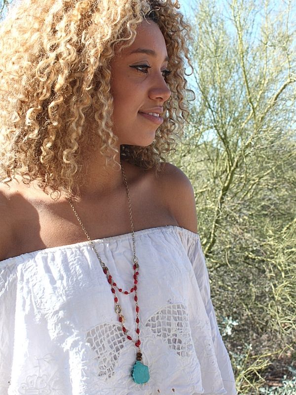 wearing white boho top & gemstone necklace