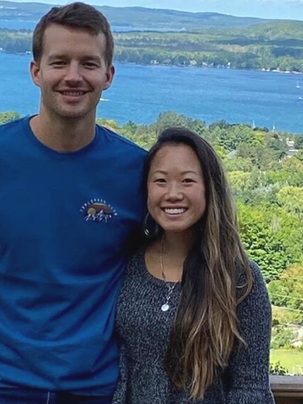 a couple outside while wearing a necklace