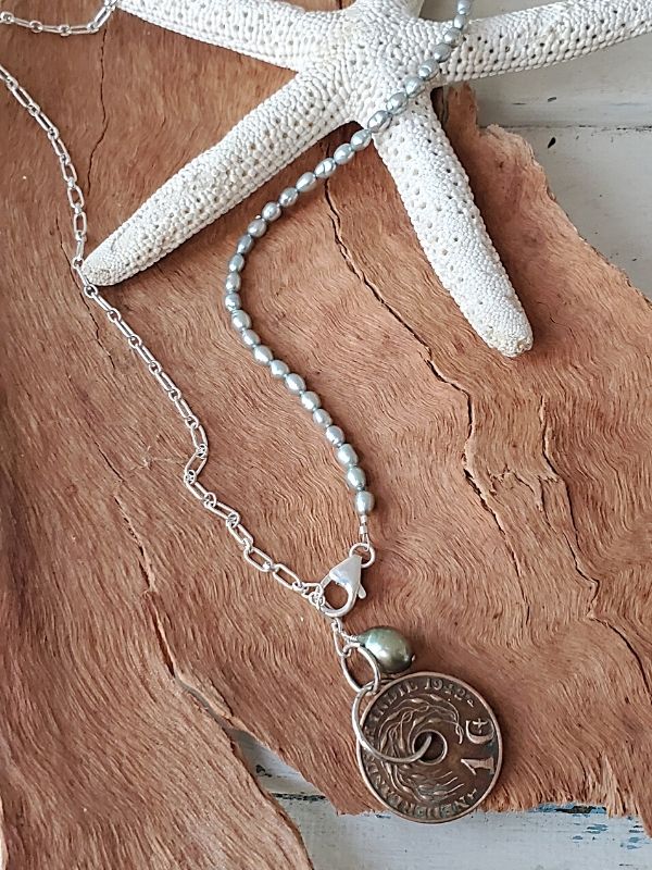 blue pearl Nederland coin necklace on a starfish