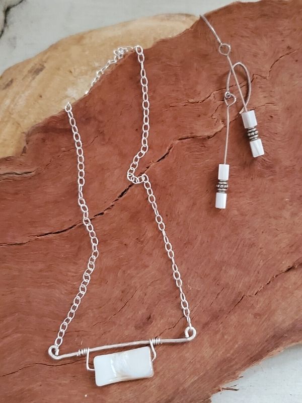 mother of pearl necklace & earrings on wood