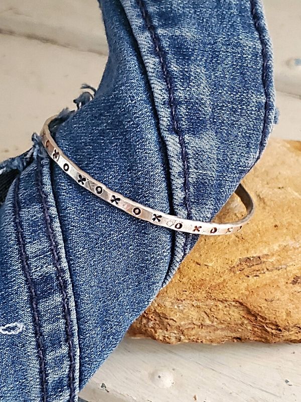 silver xox cuff bracelet with denim