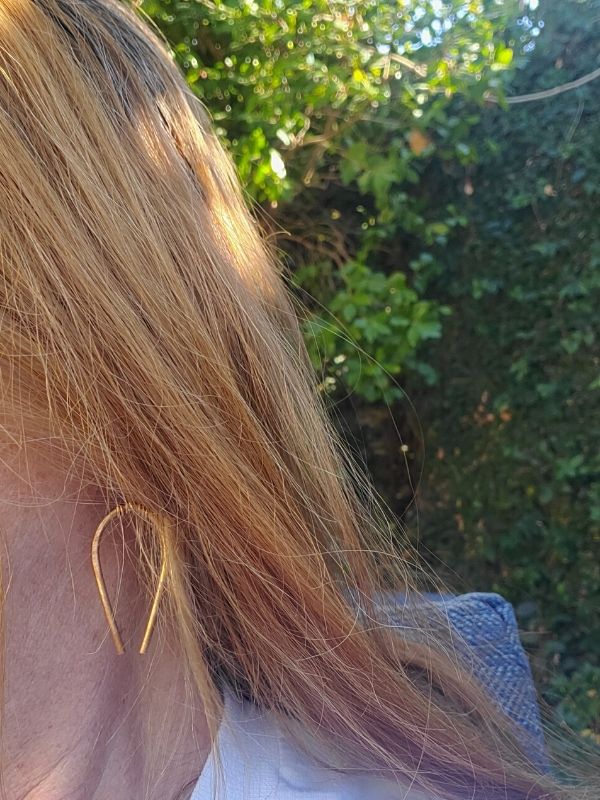 hand forged horseshoe earrings being worn