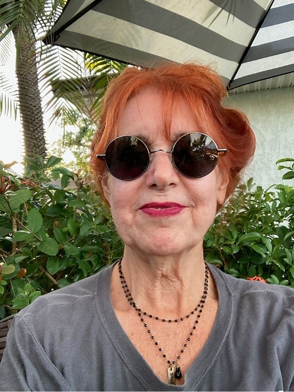 wearing a layered black beaded necklace outside