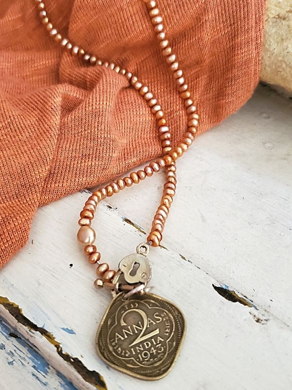 peach pearl Coin necklace on peach sweater