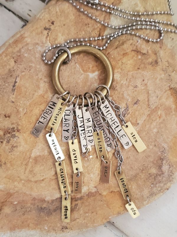 Handcrafted mixed metal children name necklace on rocks