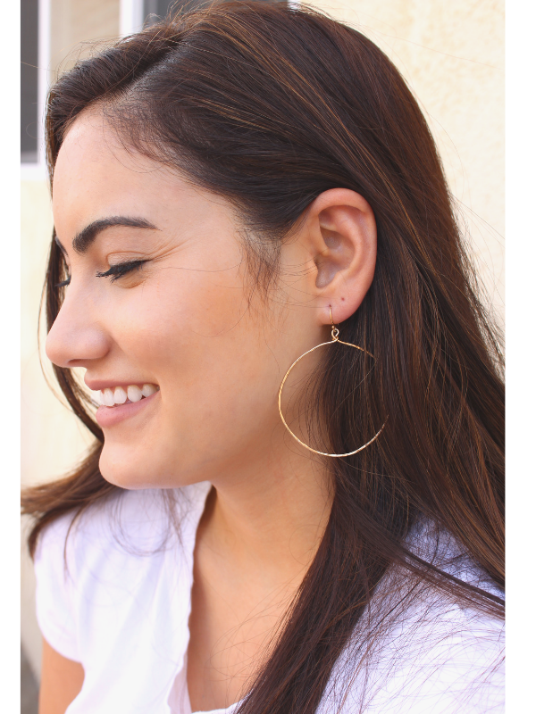 long dark hair female with big hoop eaarings