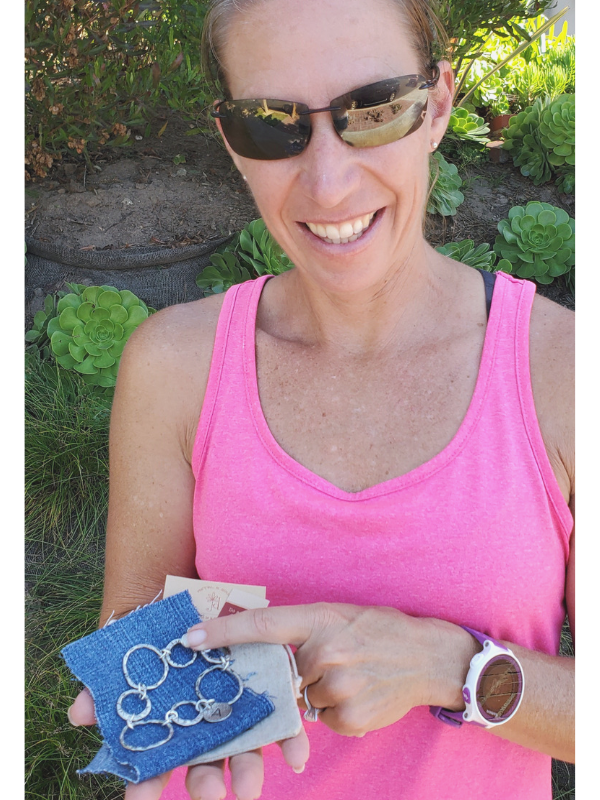 women in pink top holding bracelet gift