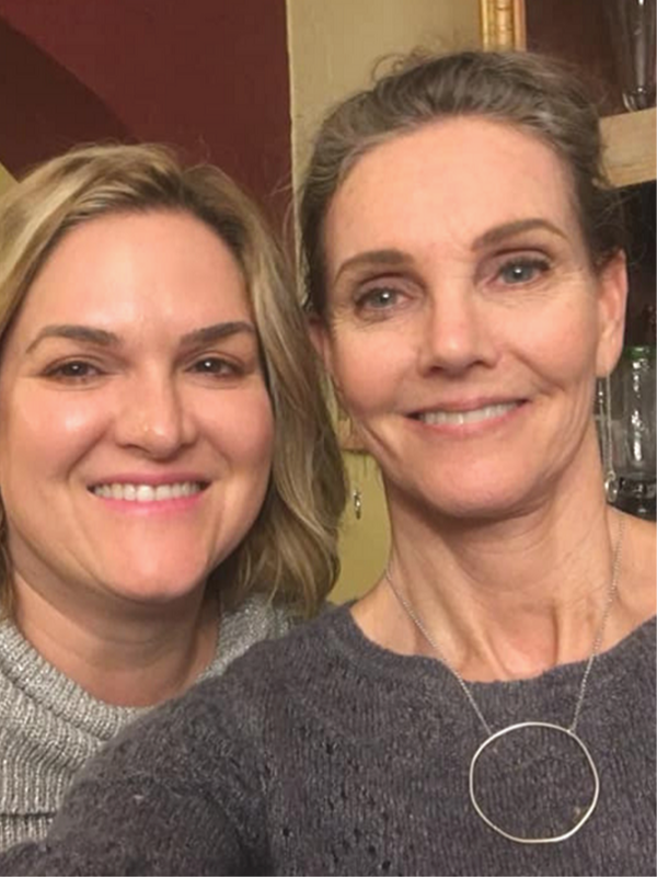 woman with friend wearing silver circle necklace