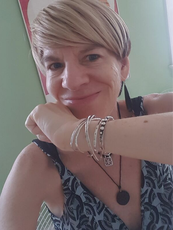 bracelet stack on arm and wearing black necklace