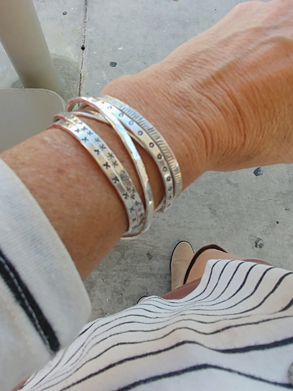 set of textured sterling cuff bracelets on arm