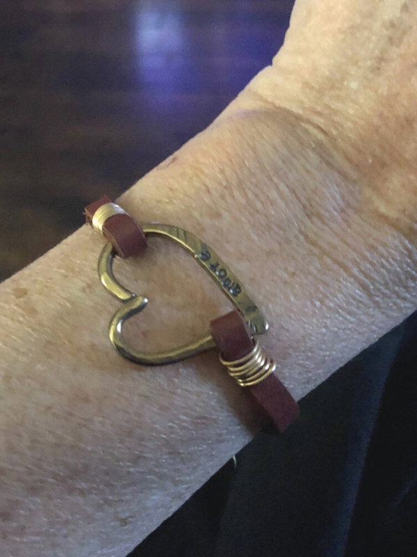 arm with big open heart leather bracelet