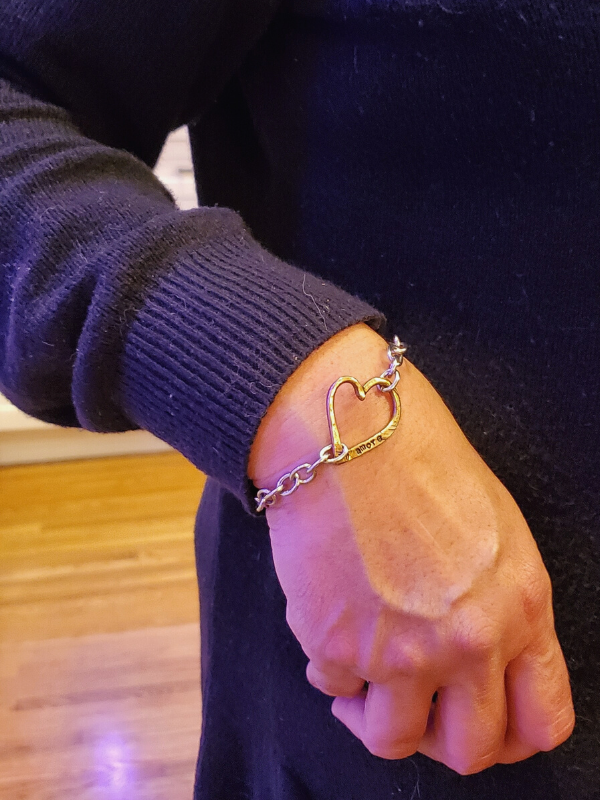 big chunky heart bracelet in wrist with black top